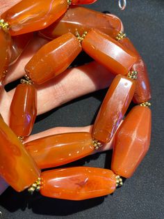 The red color carnelian beads from my collections The origin of this beads from Tibet Himalaya although the carnelian agate can be found in Nepal Pakistan India and Afghanistan as well carnelian agate was used as prayers beads in mala and used as jewelry and amulet as well old agate and carnelian was used as trade items as well in ancient times The age of this beads are more than 1000 years some gold color brass beads are used as spacers very smooth and shinny surface of this beads because of lo Orange Gemstone Beads For Jewelry Making, Handmade Carnelian Beads For Jewelry Making, Amber Natural Stones Beads For Jewelry Making, Amber Beads For Jewelry Making With Natural Stones, Gift Carnelian Faceted Beads, Amber Natural Stones For Jewelry Making, Polished Amber Beads For Jewelry Making, Carnelian Beaded Necklace With Large Beads As Gift, Hand-strung Orange Agate Beads