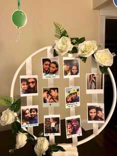 a photo collage with white roses and photos on the frame is displayed in front of a mirror