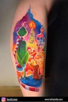 a colorful tattoo on the arm of a person with a christmas tree and santa clause