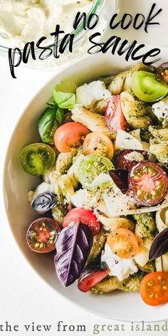 a white bowl filled with pasta salad next to a glass of milk and a spoon