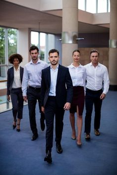 a group of business people walking down a hallway