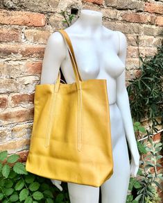 Large tote leather bag in YELLOW. Large enough for laptops, tablets, books etc. Natural GENUINE leather  Longer and shorter straps, can be carried as a shoulder or handbag. The inside of the bag is not lined. The bag is closed with a zipper at the top. Soft but strong genuine leather.  Width upper part: 34 cm - 13 1/4 inch Height: 36 cm -  14  inch This bag in different colors and other leather Bags by Good Times Barcelona:  https://www.etsy.com/shop/goodtimesbarcelona?section_id=18820154&ref=sh Trendy Yellow Office Satchel, Yellow Large Capacity Rectangular Shoulder Bag, Yellow Large Capacity Satchel For Office, Yellow Rectangular Satchel With Large Capacity, Yellow Large Capacity Shoulder Bag For Office, Large Capacity Yellow Shoulder Bag For Office, Yellow Large Capacity Bags For Daily Use, Yellow Office Shoulder Bag With Adjustable Strap, Trendy Yellow Shoulder Bag For Office