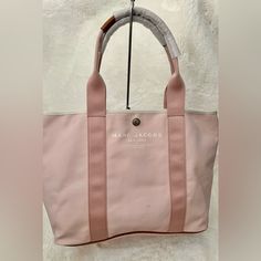 Beautiful Marc Jacobs Tote Bag Nwt Color Light Pink With Brown Leather Accent Size 18x12x7 Big Size Small Hardly Visible Marks 100% Authentic Large Capacity Pink Canvas Tote Bag, Pink Large Capacity Canvas Shoulder Bag, Everyday Pink Canvas Satchel Bag, Pink Large Capacity Shoulder Bag For Errands, Pink Double Handle Canvas Bag For Daily Use, Large Capacity Pink Canvas Bag, Pink Canvas Shoulder Bag, Large Capacity Pink Canvas Shopping Bag, Pink Top Handle Bag For Errands