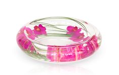 a glass bowl with pink flowers in it