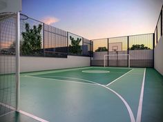 an indoor basketball court is shown in this 3d image with the sun setting behind it