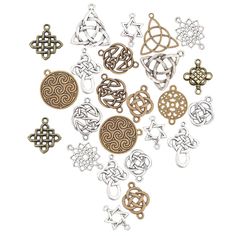 many different types of metal charms on a white background, including one with an intricate design