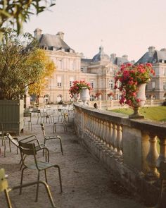 an instagram photo with chairs and flowers on the balcony in front of some buildings