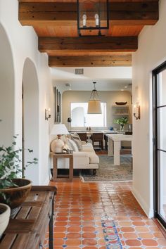 a living room filled with furniture and a wooden ceiling