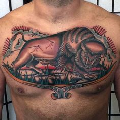 a man's chest with an animal tattoo on it