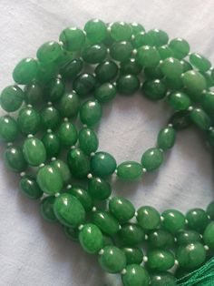 108 Beads AAA 968 Carat Emerald Dyed Japa Mala Prayer Green Color Oval Beads Japa Mala Guru bead Necklace // Long Tassel Necklace// Meditation japa mala // Guru bead// Necklace Yoga Beads Stone - Emerald Dyed Shape - Oval Size - Approx - 10x12mm Colour - Green It is known as the 'love stone' as the message it emits is the strong vibration of unconditional love, joy, warmth and healing. As quartz crystals are profound amplifiers of energy, it may help to kindle happiness, love, romantic feelings Green Round Meditation Beads, Spiritual Beaded Necklace With Faceted Oval Beads, Spiritual Beaded Necklaces With Faceted Oval Beads, Green Hand-strung Mala With Round Beads, Green Hand-strung Mala, Traditional Hand-strung Jade Beaded Necklace, Green Gemstone Beads Mala, Traditional Jade Beaded Necklaces With Gemstone Beads, Handmade Oval Spiritual Beaded Necklaces