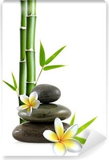 an image of bamboo and stones with flowers