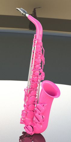 a pink saxophone sitting on top of a table