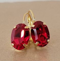 "♡ Genuine Austrian Crystal ♡ Yellow gold plated (nickel free) ♡ 14mm x 10mm Oval Rhinetones ♡ Color: Light Siam ♡ 1\" long, 3/8\" wide ♡ Lever backs ♡ Hand set with love and attention to detail" Ruby Drop Earrings, Red Ruby Earrings, Bridal Drop Earrings, Woman Earrings, Minimalist Earring, Earring Wedding, Bridal Earrings Drop, Ruby Earrings, Earrings Red