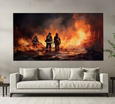 two fire fighters standing in front of a large painting on the wall above a couch