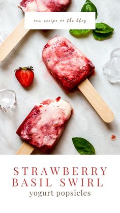 strawberry basil swirl yogurt popsicles on ice with mint leaves and strawberries