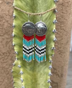 Handmade with delica beads and silver plated replica Buffalo Nickel Conchos. Sterling Silver ear wire Length: approx. 7.7 cm (ear wire included) Width: approx. 2.6 cm (with concho)  Width: approx approx. 1.5 cm (without concho) Please feel free to reach out if you have questions! Native American Beadwork Patterns, Beautiful Beaded Earring, Beaded Jewelry Earrings, Leather Tooling Patterns, Tooling Patterns, Beaded Earrings Native, Beaded Heart, Buffalo Nickel, Native American Beadwork