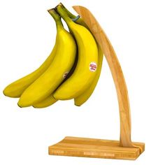 three bananas are hanging from a wooden stand on a white background with clippings