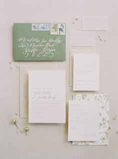 the wedding stationery is laid out on top of each other