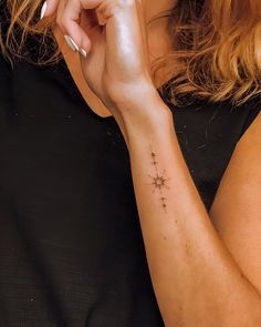 a woman with a small star tattoo on her arm