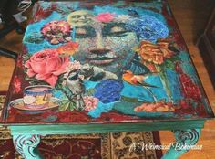 a painted table with flowers on it and a bird sitting on top of the table