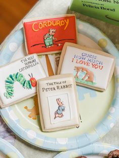 there are four cookies on the plate and one is for peter rabbit, which has been decorated with children's books