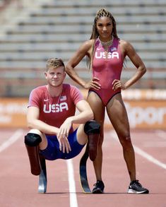 two athletes posing for the camera on a track with their legs crossed and one standing behind them