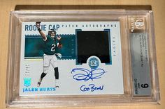 an autographed football card is on display in a clear plastic case with the name and number