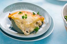 a slice of quiche with broccoli and cheese on a plate next to a salad