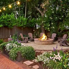 an outdoor fire pit surrounded by chairs and trees