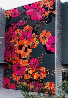 a large mural on the side of a building with flowers painted on it's sides