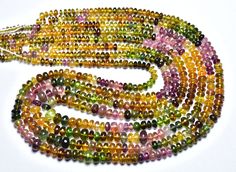 multicolored glass beads are arranged on a white surface