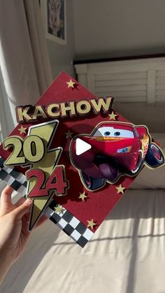 someone holding up a card with the character from cars