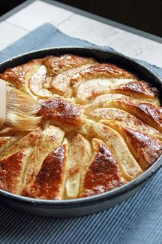 an apple pie with powdered sugar on top is in a pan and ready to be eaten