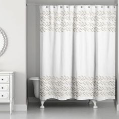 a bathroom with a shower curtain, mirror and white dresser in front of the tub