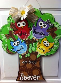 a door hanger with three owls on it