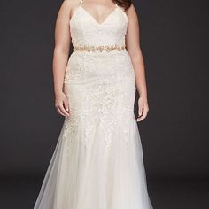 a woman in a white wedding dress posing for the camera