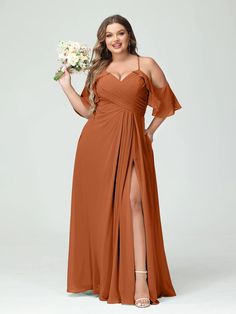 a woman in an orange bridesmaid dress posing for the camera with her bouquet