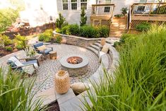 an outdoor fire pit surrounded by tall grass