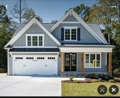 a house with two garages and three windows