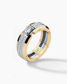 a gold and silver ring with diamonds