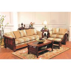 a living room filled with furniture on top of a hard wood floor covered in rugs