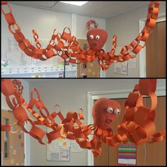 an octopus made out of orange ribbon hanging from the ceiling