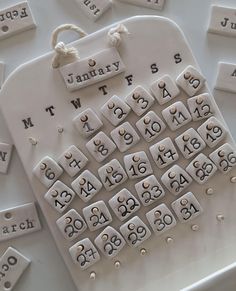 a close up of a keyboard made out of letters and numbers on a white surface