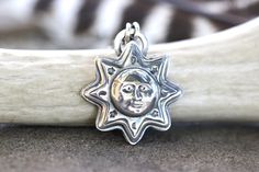 "This listing is for one gorgeously detailed and old timey sterling silver celestial sun face pendant. It is very much like the vintage suns and moons found on carnival tents or old Tarot cards. A wise sun face is surrounded by crescent moon and star symbols. I I make these witchy pendants 100% by hand using sterling silver sheet and steel dies made as replicas of vintage jewelry designs in my hydraulic press, slowly forging the sheet into the shape. I then saw out the shape and fire it onto a b Celestial Sterling Silver Jewelry For Festival, Sterling Silver Celestial Jewelry For Festivals, Celestial Style Sterling Silver Jewelry For Festivals, Collectible Celestial Sun And Moon Jewelry, Celestial Sun And Moon Collectible Jewelry, Silver Celestial Necklace With Sun Design, Silver Sun And Moon Festival Jewelry, Sterling Silver Sun And Moon Festival Jewelry, Vintage Silver Jewelry With Sun Design