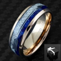 two tone gold and blue ceramic wedding ring with silver inlays, set on a black background