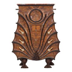 an ornate wooden cabinet with carved designs on the front and sides, including two legs