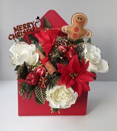 a red box filled with flowers and a gingerbread