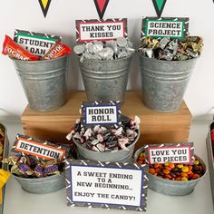 an assortment of candy in buckets on a table with signs that say,'thank you