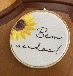 a yellow sunflower with the words ben windsor written in cursive writing on it