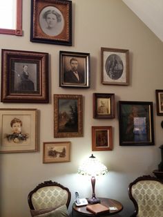 there are many framed pictures on the wall